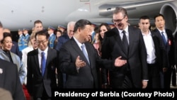 Chinese President Xi Jinping and Serbian leader Aleksandar Vucic meet at the airport late on May 7.