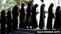 Afghan female students stand in line after they arrive for entrance exams at Kabul University earlier this year.