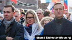 От ляво надясно: директорът на "Щабовете на Навални" Иван Жданов, юристката Любов Собол и Алексей Навални по време на митинг, отбелязал 5-ата годишнина от убийството на опозиционния политик Борис Немцов.