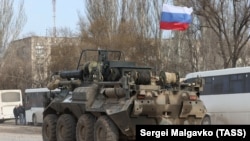 UKRAINE -- CRIMEA -- A Russian armoured vehicle moves across the town of Armyansk, northern Crimea, early on February 24.