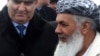 File photo of Ismail Khan with a Tajik official.