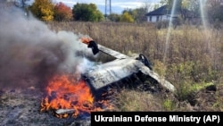 UKRAINE – In this photo provided by the Ukrainian Defense Ministry Press Service, fragments of a Russian rocket that was shot down by the Ukrainian air defence system burn down in the village of Kipti, Chernihiv region, October 19, 2022