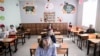 KOSOVO -- Students wearing a 3D printed face shield and gloves attend a class at the "Faik Konica" primary school in Pristina , June 9, 2020