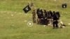 FILE: Grab from a video that shows militants loyal to the Islamic State (IS) blowing up bound and blindfolded Afghan prisoners with explosives. The victims were from Nangarhar Province. IS released the video in August 2015.