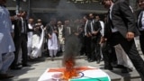 Lawyers burn a banner with a picture of India's national flag and Prime Minister Narendra Modi during an anti-India protest in Multan, Pakistan, on April 28.