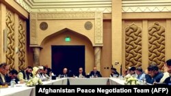 Negotiators from the government of Afghanistan get ready for a meeting with representatives of the Taliban (unseen) in Qatar's capital Doha, on September 15.