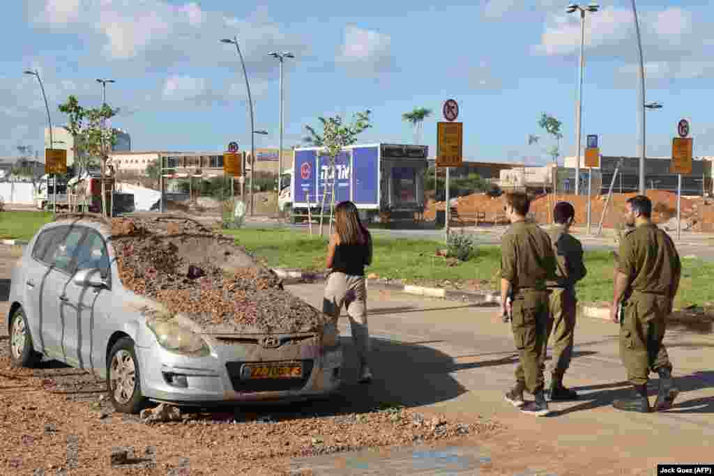 A car is covered in dirt apparently kicked up by a rocket impact in Tel Aviv. The photo was taken on the morning of October 2 after Iran launched a massive rocket attack on Israel the previous evening. 