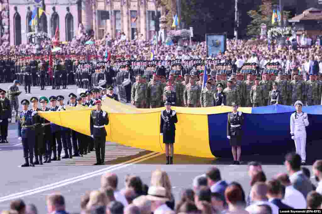 Ukrainian soldiers march with their country's national flag on Independence Square.