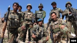 Afghanistan -- Afghan soldiers pose for a group photo during a patrol to take back the control of Baba Ji district from Taliban militants in Helmand province, February 14, 2016