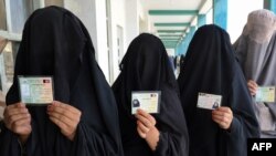 Afghan women wait to cast their votes in Kandahar