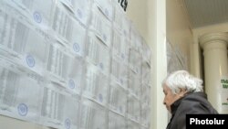 Ընտրություններ Հայաստանում. կինը քվեարկելուց առաջ ծանոթանում է ընտրատեղամասի պատին փակցված ընտրացուցակներին, արխիվ