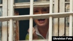 European leaders and international rights groups have condemned the cases against former Ukrainian Prime Minister Yulia Tymoshenko -- seen here through the window of her Kyiv prison on November 4 -- as politically motivated and urged her release.