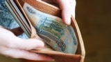 GENERIC – Russian rubles banknotes in hands during the war in Ukraine. Inflation, sanctions and the fall of the Russian economy concept. Falling cash savings and budget