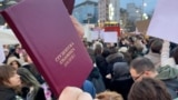 SERBIA - BELGRADE - STUDENTS PROTESTING - HOLDING STUDENT'S TRANSCRIPT