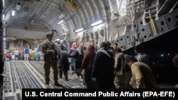 Evacuarea civilior străini și afgani, la bordul unui avion militar american, Kabul, Afganistan, 22 august 2021.