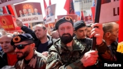 People attend a march in support of former Kosovo President Hashim Thaci ahead of his trial for alleged war crimes, in Pristina on April 2.