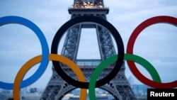 FILE PHOTO: Olympic rings to celebrate the IOC official announcement that Paris won the 2024 Olympic bid are seen in front of the Eiffel Tower at the Trocadero square in Paris