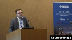 Ion, ținând un discurs la Vehicular Networking Conference, în 2019.