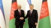 Uzbekistan's President Shavkat Mirziyoev (R) shaking hands with the Afghan President Ashraf Ghani in Tashkent on March 27.