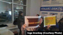 Демпартия құруды көздейтін топтың жиынына келген әйелдер қолдарына плакат ұстап тұр. Нұр-Сұлтан, 24 қараша 2019 жыл.