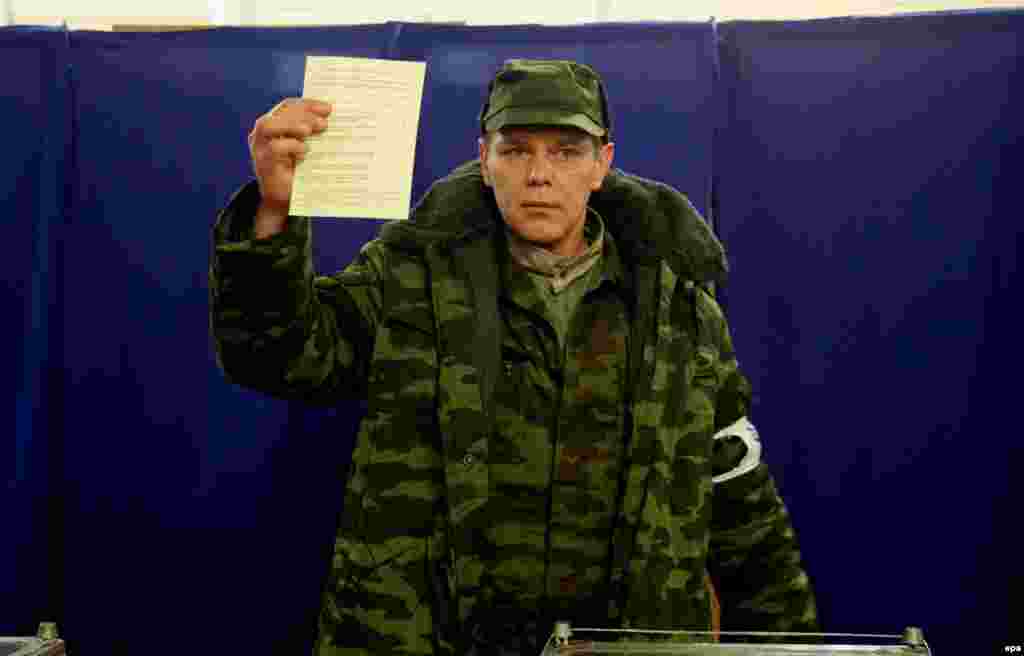 Член одного из пророссийских «отрядов самообороны Крыма» показывает журналистам свой бюллетень с отметкой в графе «За вхождение в состав России»