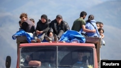 Armenia - Refugees from Nagorno-Karabakh region ride in a truck upon their arrival at the border village of Kornidzor, September 27, 2023. 