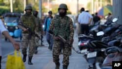 Indian paramilitary soldiers patrol as they guard at a busy market in Srinagar in Indian-administered Kashmir on April 29.