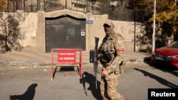 Въоръжен боец, участвал в офанзивата, свалила от власт сирийския президент Башар ал-Асад, минава пред затвореното посолство на Турция в Дамаск, 14 декември 2024 г.