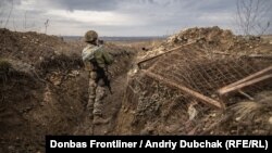 Український військовий з котом у окопі передової поблизу Світлорадська, 2 грудня 2021 року
