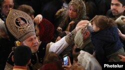 Armenia - Catholicos Garegin II blesses a child after a Christmass mass at St. Gregory's Cathedral in Yerevan, January 6, 2019.