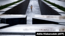 Un turist se plimbă în jurul Memorialului Trianon, în apropiere de clădirea parlamentului din Budapesta, în ianuarie 2021.