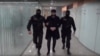 Armenia -- Narek Sarkisian is escorted by police officers at Yerevan airport after being extradited from the Czech Republic, December 21, 2019.