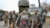 Ukrainian soldiers of the 155th Separate Mechanized Brigade stand next to military vehicles during a training exercise in France. 