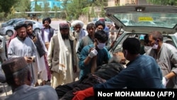 A victim, injured in an explosion at a cattle market in Sangin district, is brought to a hospital in Lashkar Gah city of Helmand Province on June 29.
