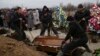 Ukraine -- People attend the funeral ceremony for Aleksandr Demyanenko who was killed during the 24 January shelling of the eastern Ukrainian city, in Mariupol, January 26, 2015